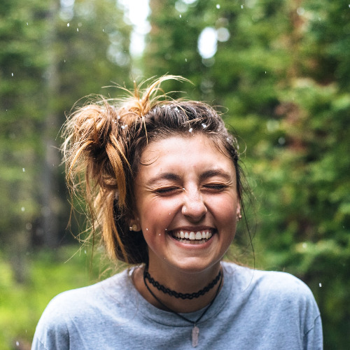 Girl enjoying rain while smiling