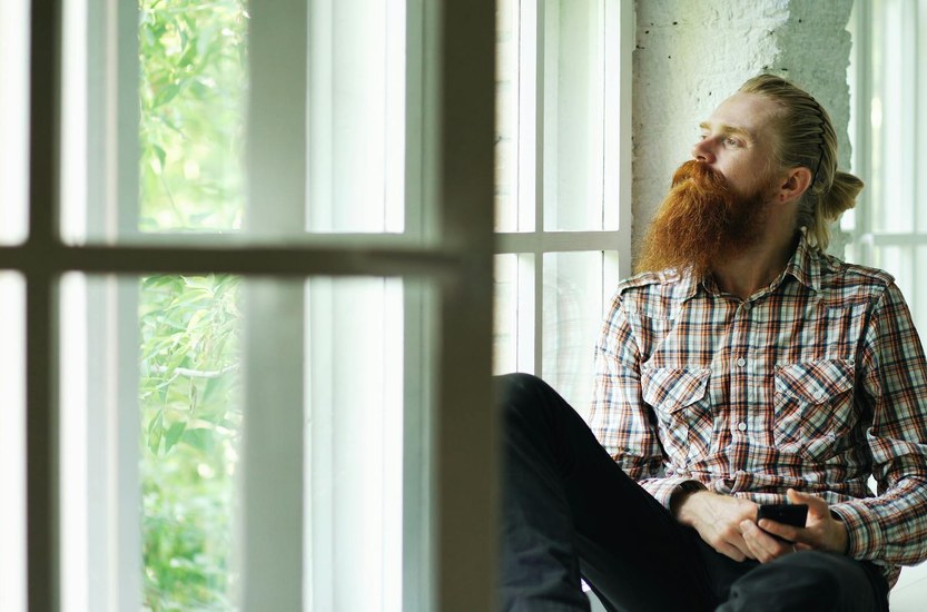 Man sitting by window looking calm and thoughtful after quitting weed benefits timeline recovery