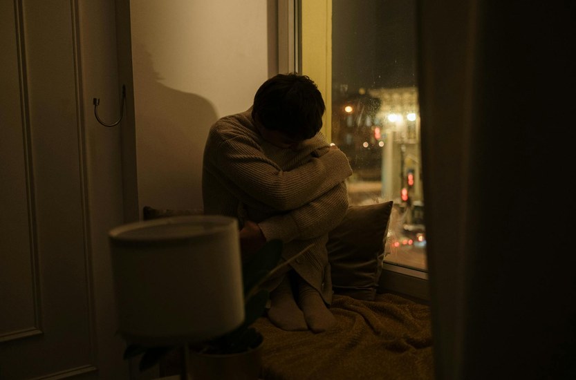 Person looking out a window dealing with low mood after quitting weed
