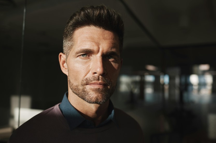 Middle-aged man close-up portrait, thoughtful expression