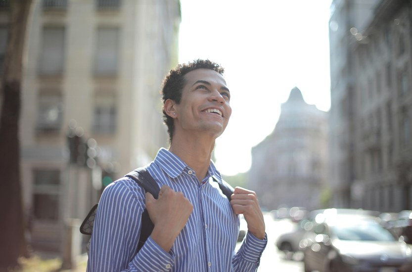 Person sitting at window in natural light looking reflective and calm