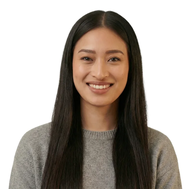 Smiling woman with long dark hair in a grey sweater
