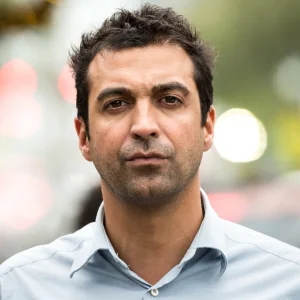 Serious man in a light blue shirt, portrait outdoors